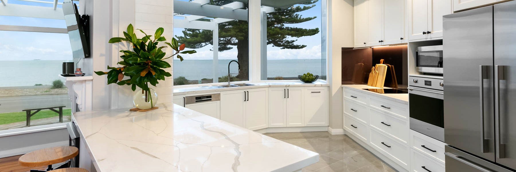An angled kitchen with an island separating kitchen from living area