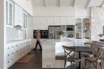 Cabinetry and island, with curved seating area Cabinetry and island, with curved seating area